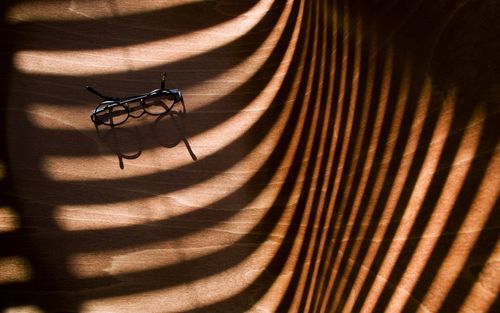 High angle view of a shadow on chair