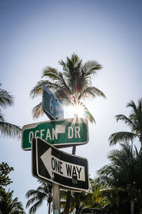 Low angle view of road sign against sky