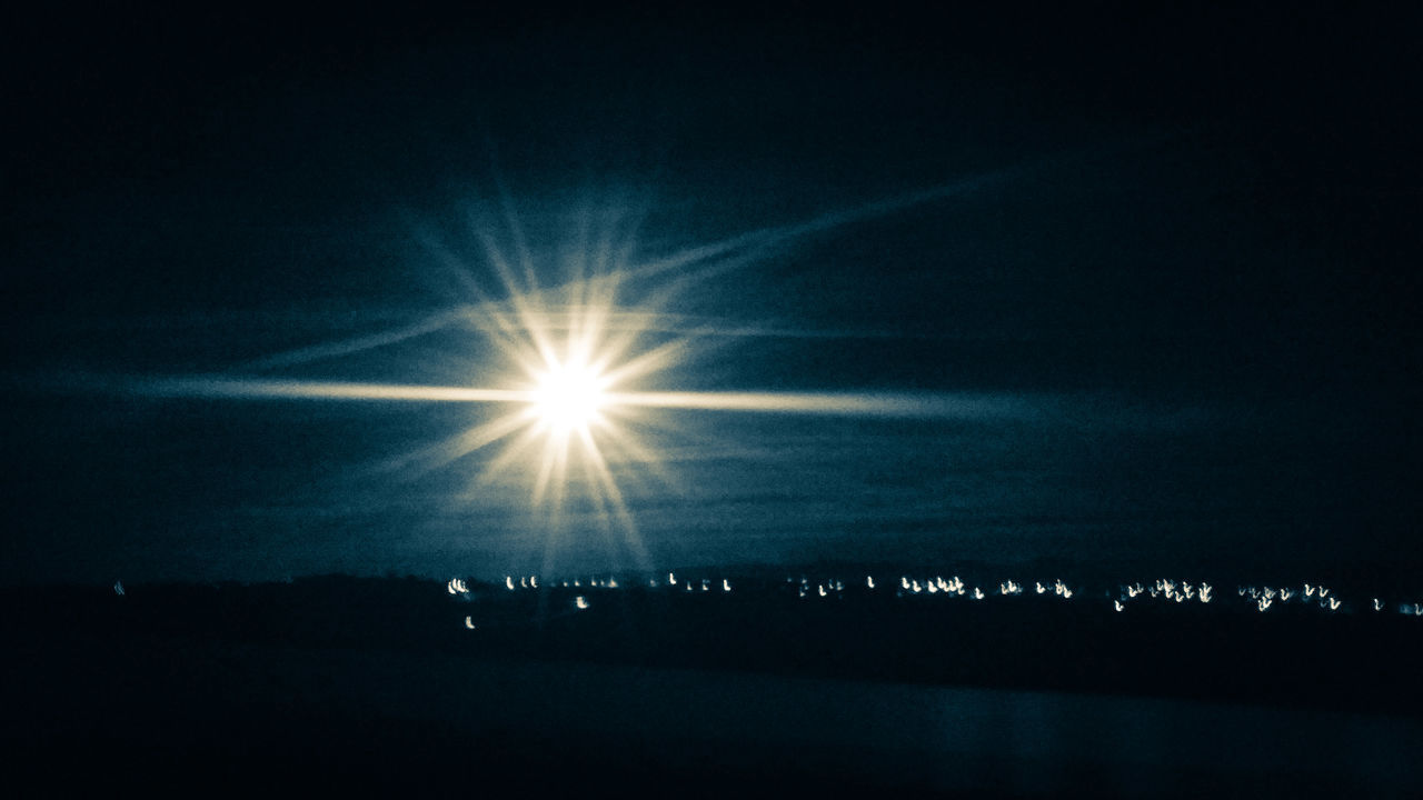 SCENIC VIEW OF ILLUMINATED LIGHTS AGAINST SKY AT SUNRISE