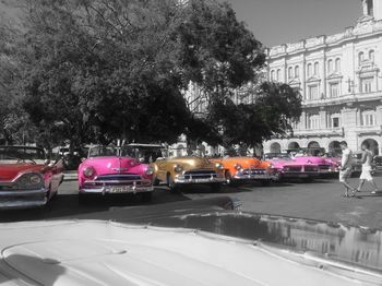 Cars on road against sky in city