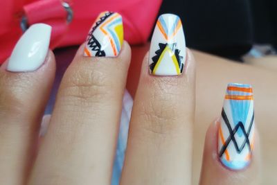 Cropped hand of woman with nail art