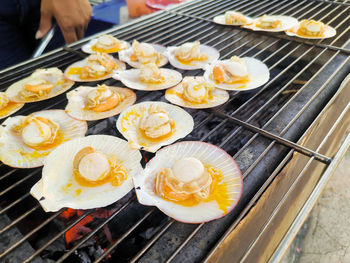 Scallops grilled with butter. freshly prepared food from seafood shop, pier market. 