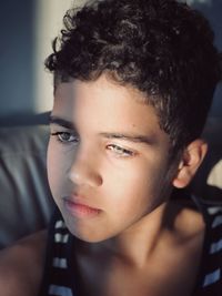 Close-up portrait of boy with green gray eyes 