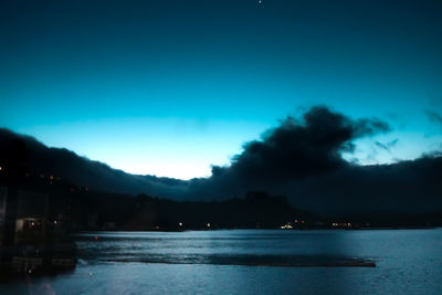 Scenic view of sea against sky at dusk