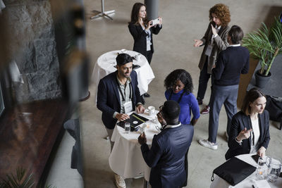 Delegates talking to each other during seminar in conference center