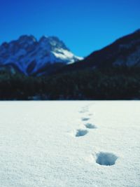 Scenic view of snow mountains against blue sky