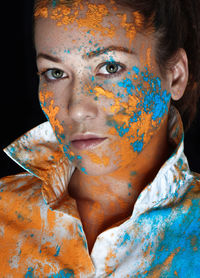 Close-up portrait of a young woman with holi