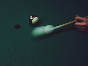 High angle view of hand playing pool