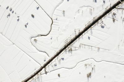 Aerial straight down from snowy landscape in ehrwald austria 