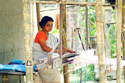 Woman weaving wool