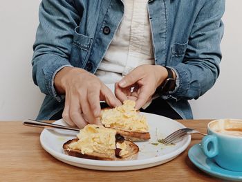 Midsection of man holding ice cream in plate