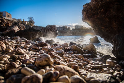 Rocks on beach against sky