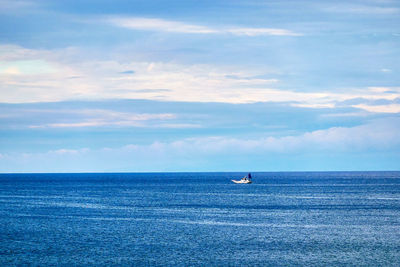 Scenic view of sea with ship against sky