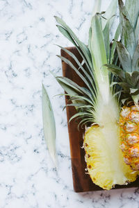 Directly above shot of halved pineapple on cutting board