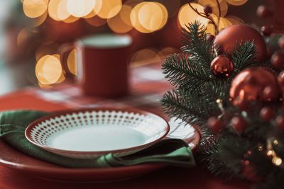 Close-up of plates with christmas decorations on table