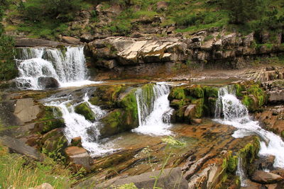 Scenic view of stream flowing through rocks