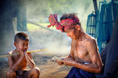 Senior man with grandson in village