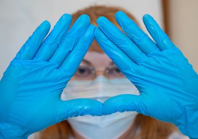 Close-up portrait of woman covering face