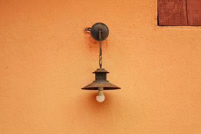 Low angle view of lamp mounted on wall