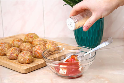 Cropped hand of person preparing food