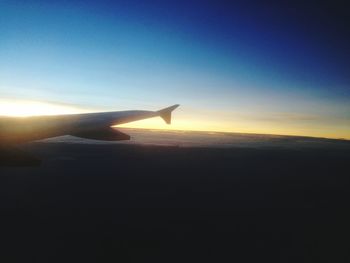Cropped image of airplane flying over landscape