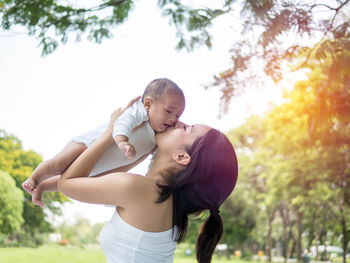 Mother with baby girl on tree