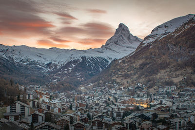 Aerial view of townscape and mountains during winter