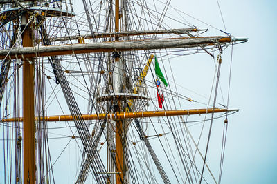 Sailboat sailing on boat against clear sky