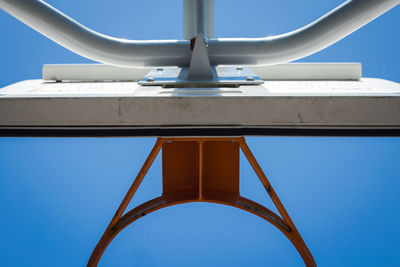 Low angle view of metallic structure against blue sky