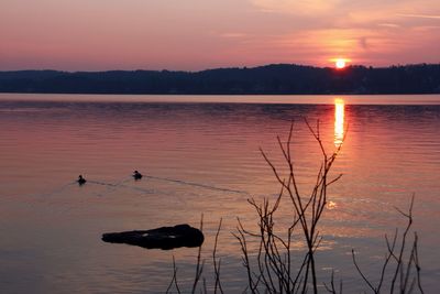 Scenic view of lake against romantic sky at sunset