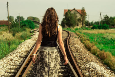 Woman standing on railroad track