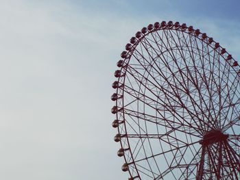 Low angle view of ferris wheel against sky