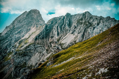 Scenic view of mountains against cloudy sky