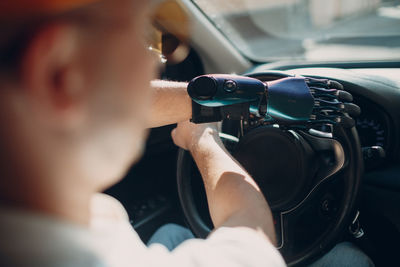 Midsection of man driving car