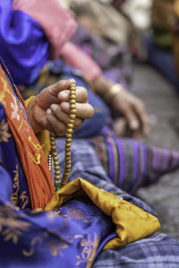 Close-up of hand holding prayer beads