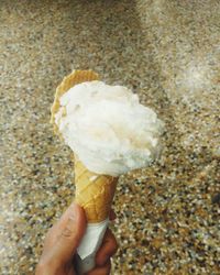 Close-up of hand holding ice cream cone