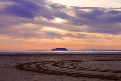 Scenic view of beach against sky during sunset