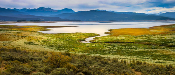 Scenic view of lake and mountains against sky