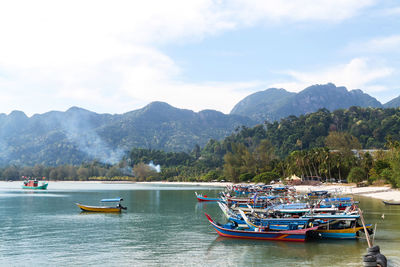 Boats in sea against sky