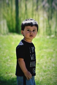 Portrait of boy standing on field