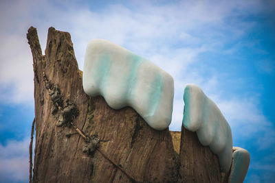 Low angle view of tree stump against sky