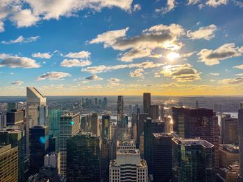 Aerial view of buildings against cloudy sky