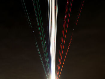 Close-up of illuminated lighting equipment against black background