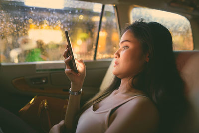 Portrait of woman sitting in car