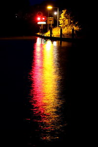 Illuminated street lights in city at night