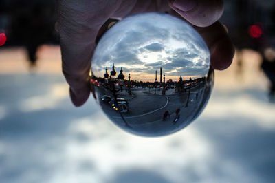 Close-up of hand holding crystal ball