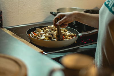 Midsection of person preparing food on table