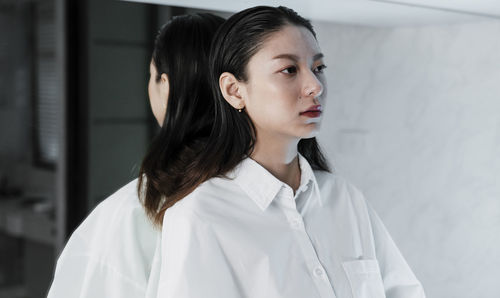 Portrait of young woman looking away