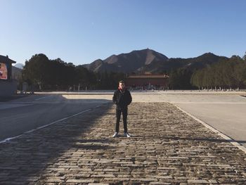 Full length of man standing on mountain against sky