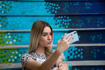 Portrait of young woman using mobile phone